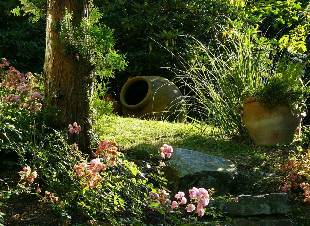 Jardín con flores y jarrones decorativos